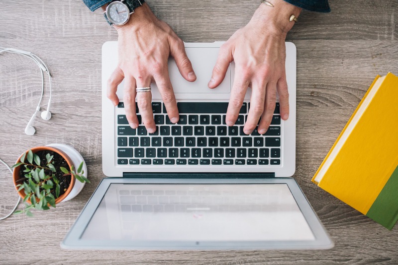 hands coding on a laptop